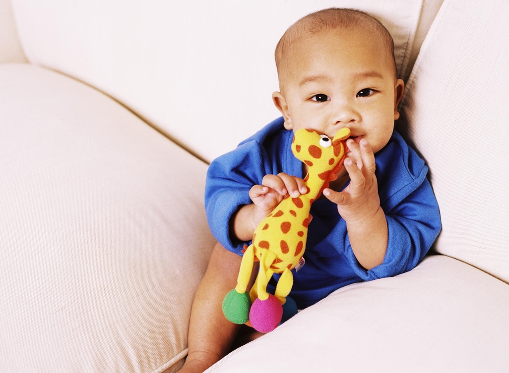 baby with toy giraffe