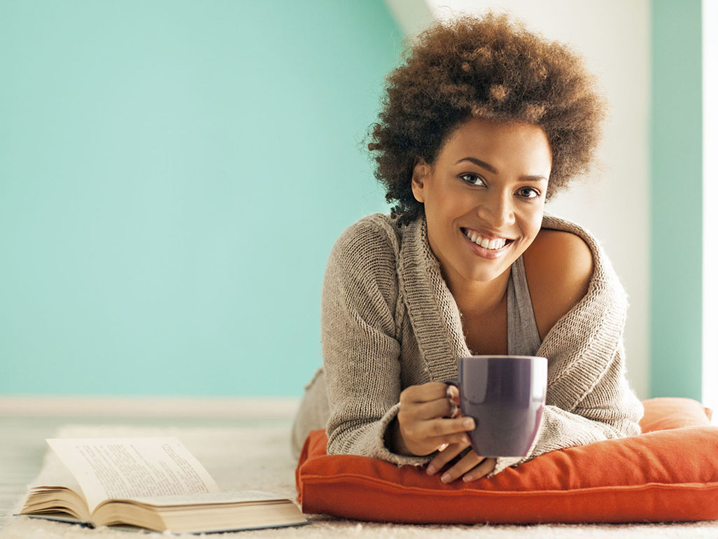 Smiling woman holding a cup
