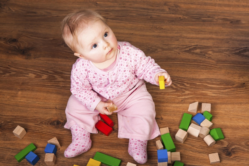 baby laying with blocks