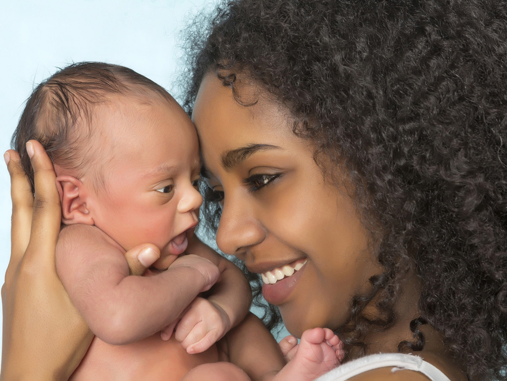 Mum holding small newborn