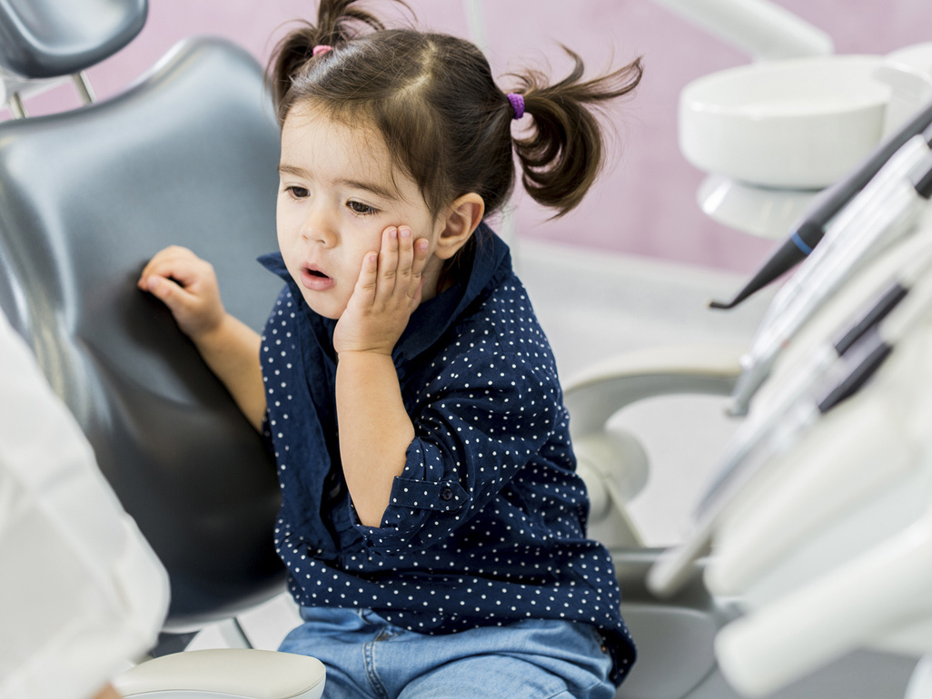 Toddler girl sitting on a dentist's chair