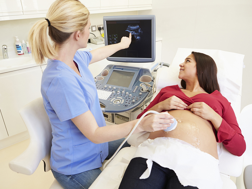 Pregnant woman having a nuchal translucency ultrasound scan