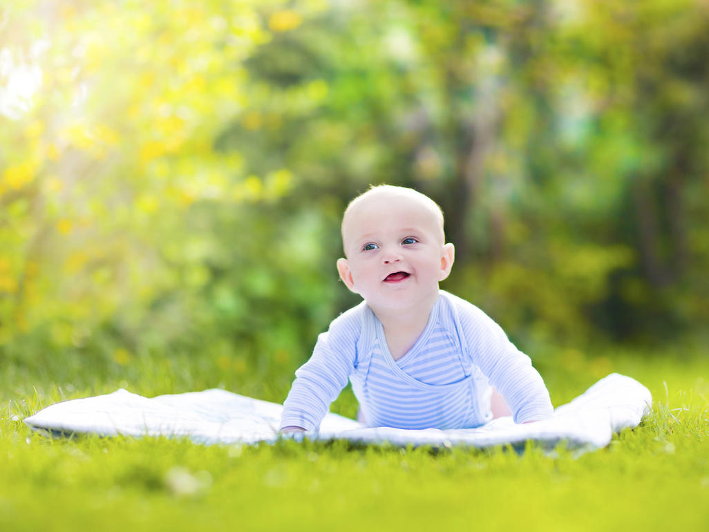 Baby on rug in garden