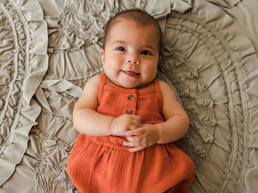 Baby smiling at the camera 