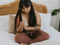 woman checking a home pregnancy test