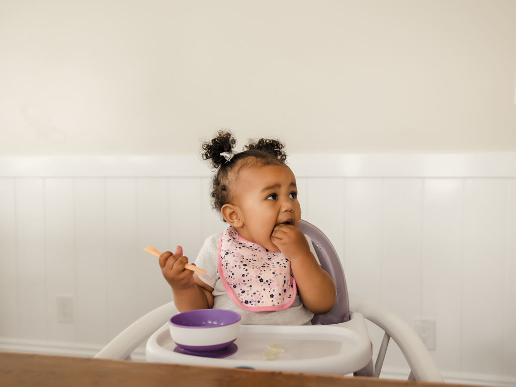 Toddler sitting in highchair eating