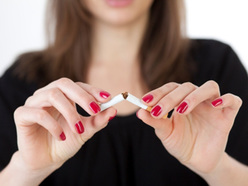 Woman snapping a cigarette in half