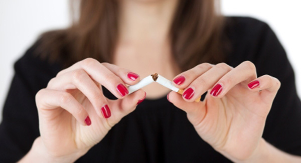Woman snapping a cigarette in half