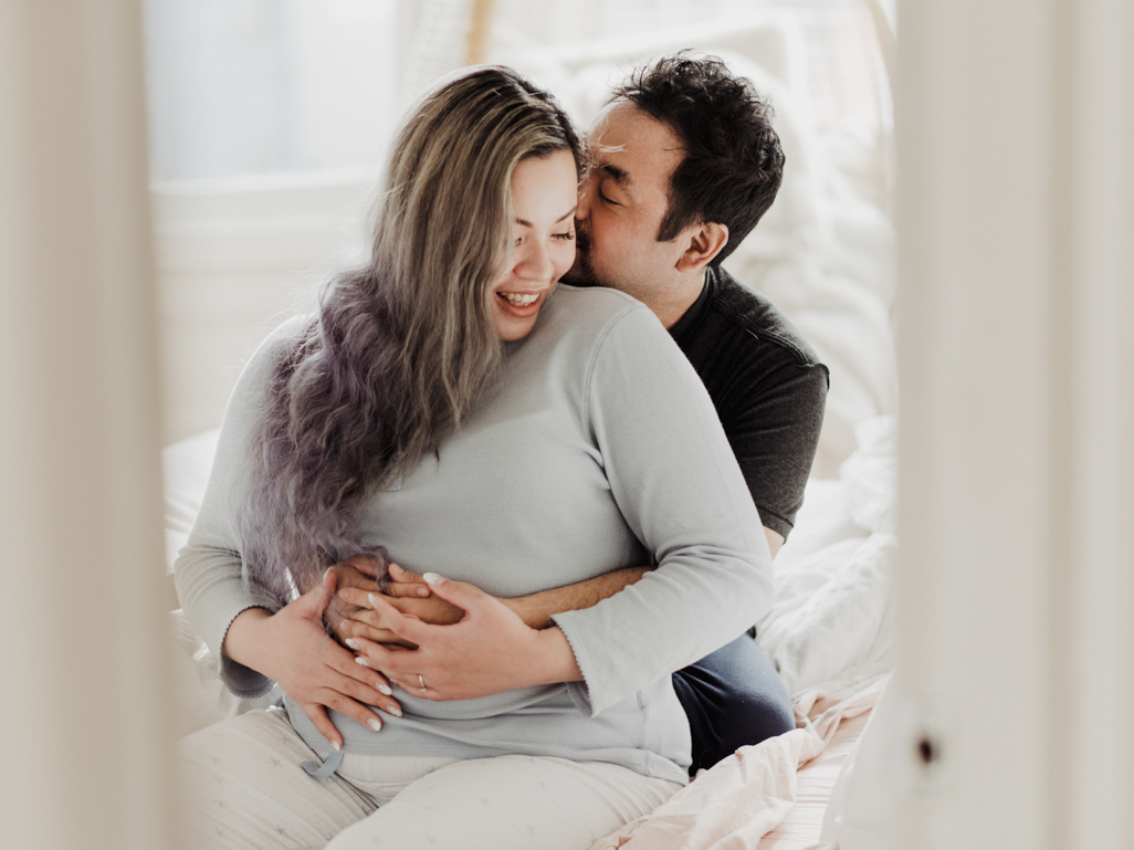 Pregnant woman and partner in bed