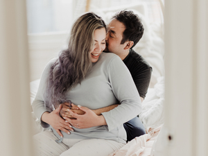 Pregnant woman and partner in bed