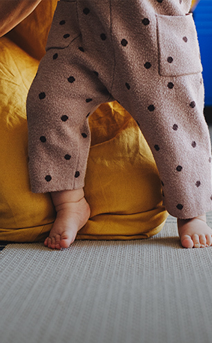 close-up of baby taking first steps