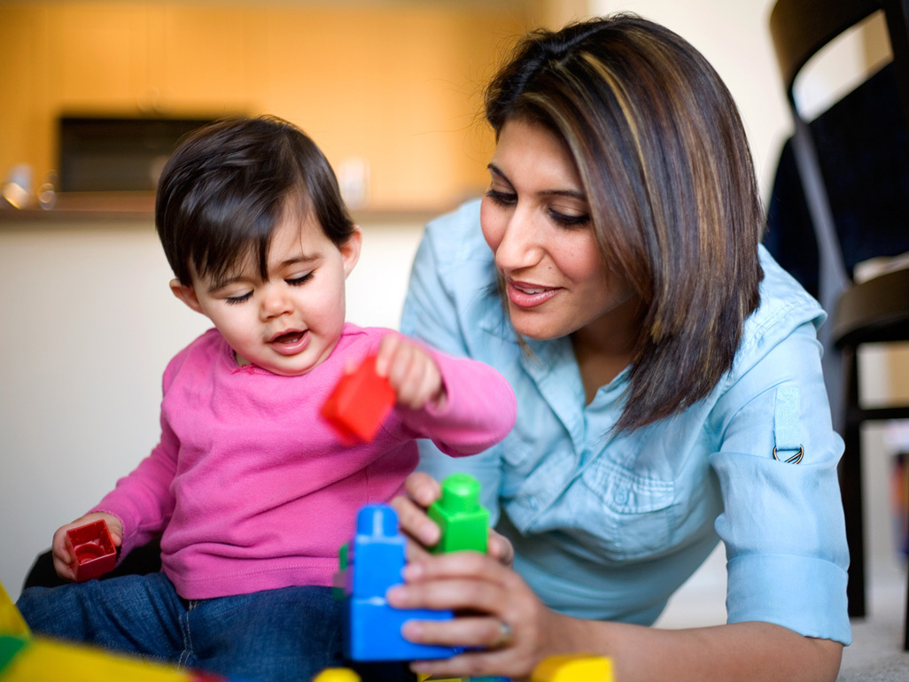 Woman playing with her son.