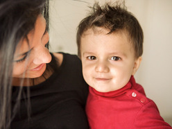 Toddler in red shirt smiling