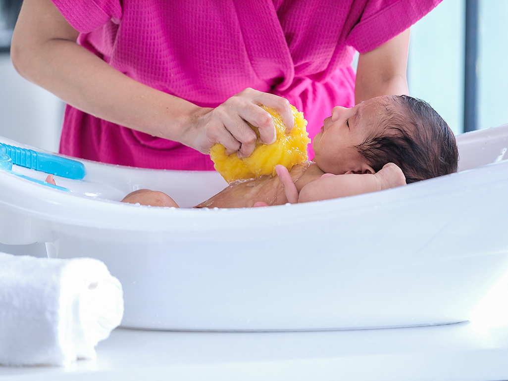Baby being bathed