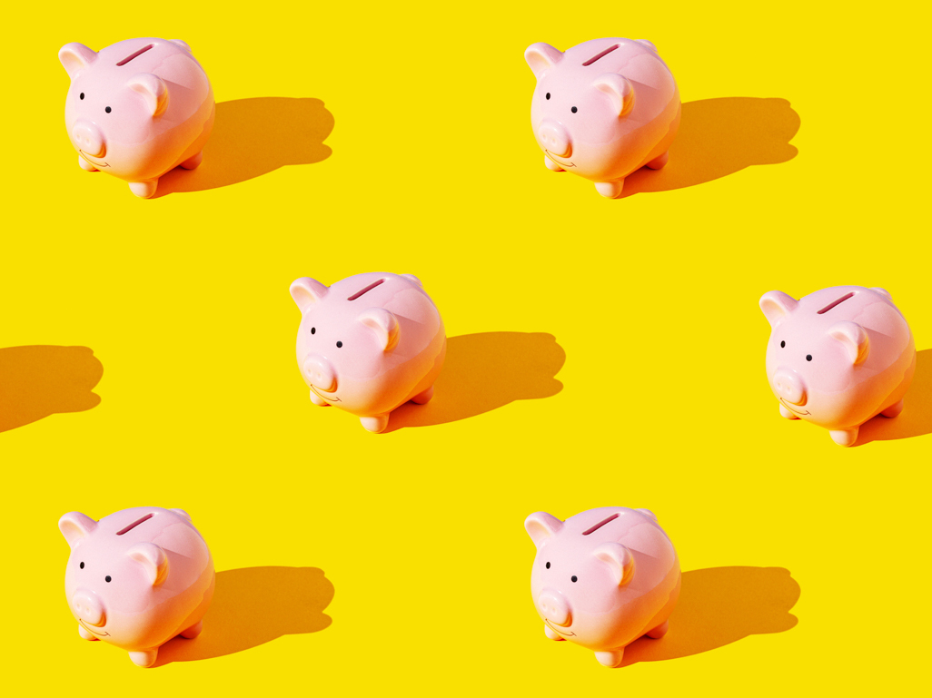 Piggy banks on yellow background