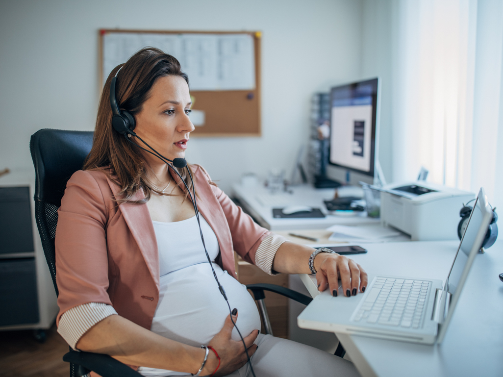 Pregnant woman at her desk in an office