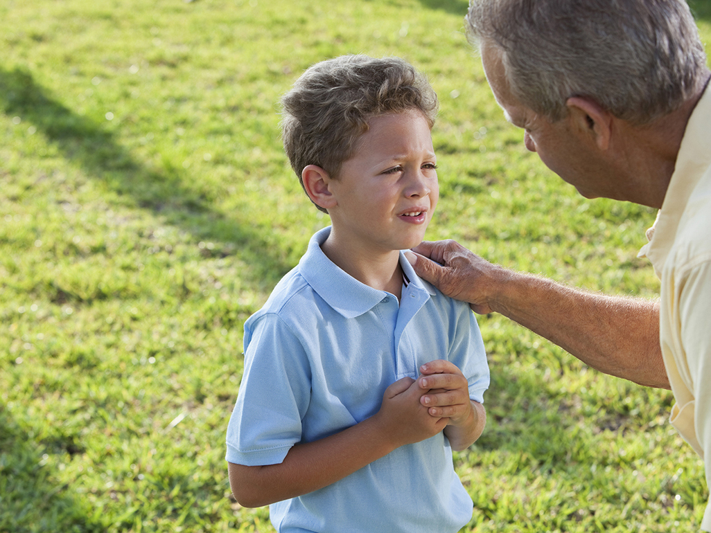 Dad talking seriously with preschooler son