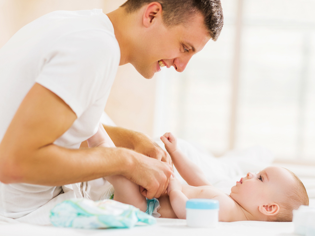 Dad changing baby's nappy