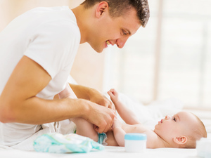 Dad changing baby's nappy