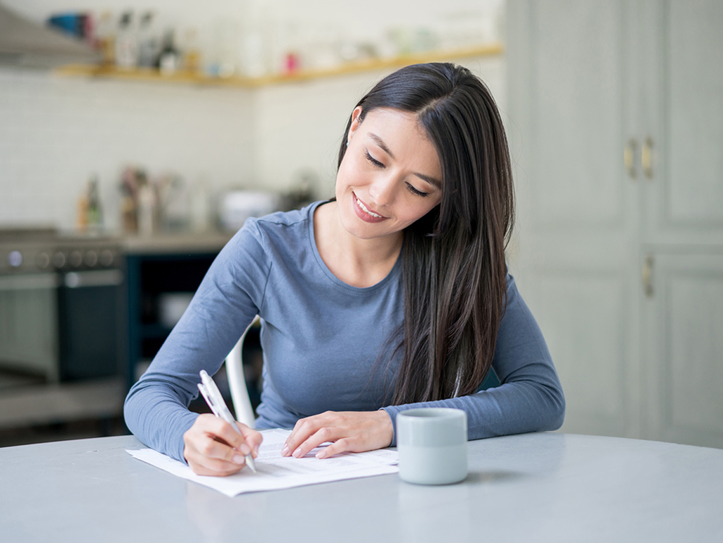 Woman writing at table