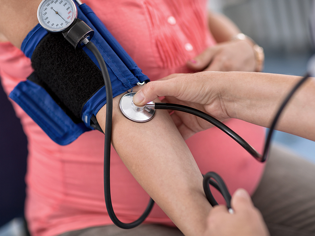 Pregnant woman having her blood pressure taken