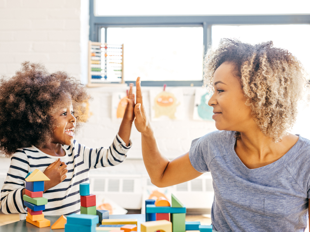 Mother and daughter playing with bricks