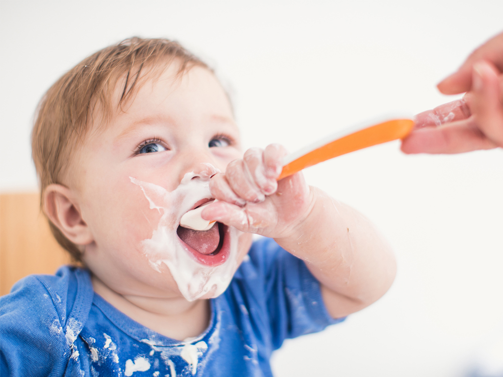Baby with food all over face
