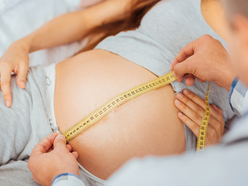 Woman having her bump measured