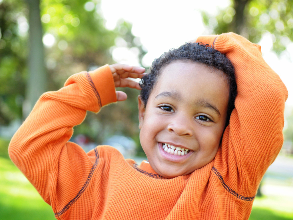 Smiling boy in park with trees