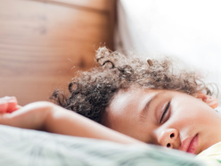 Young child asleep in bed