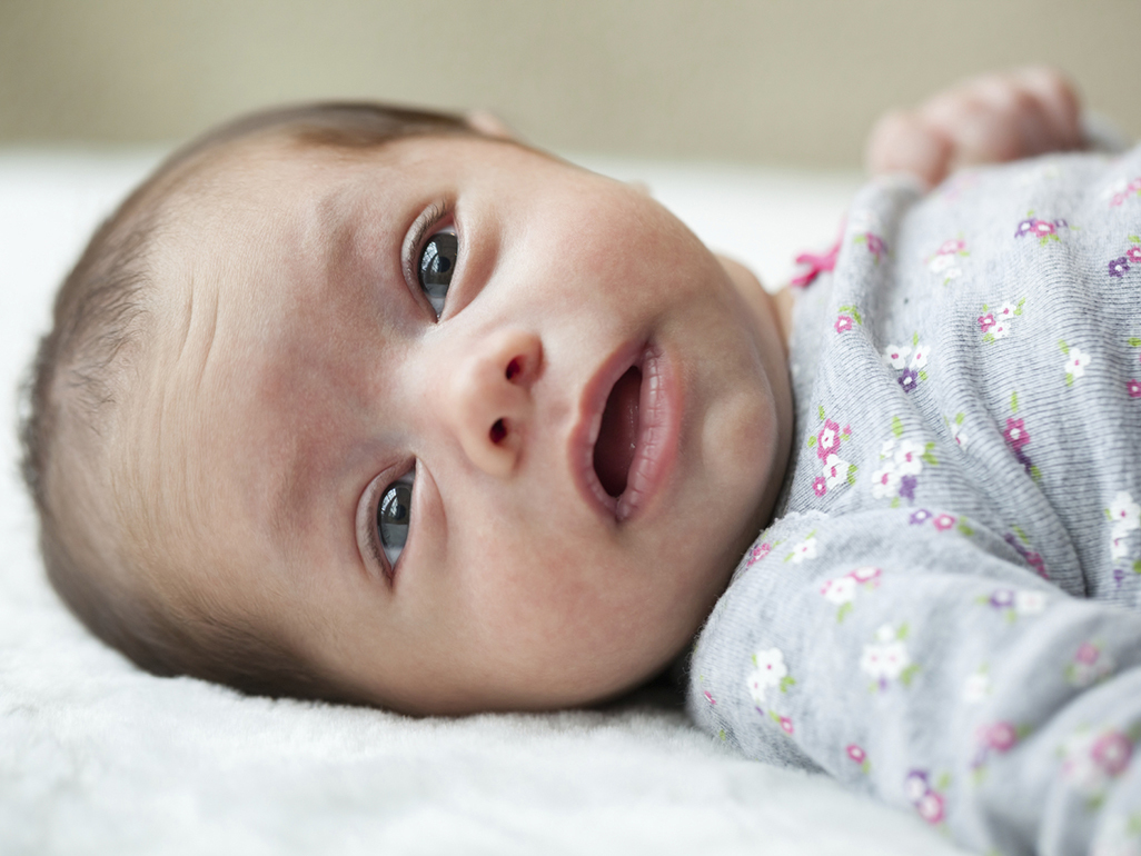 Baby lying on a mat