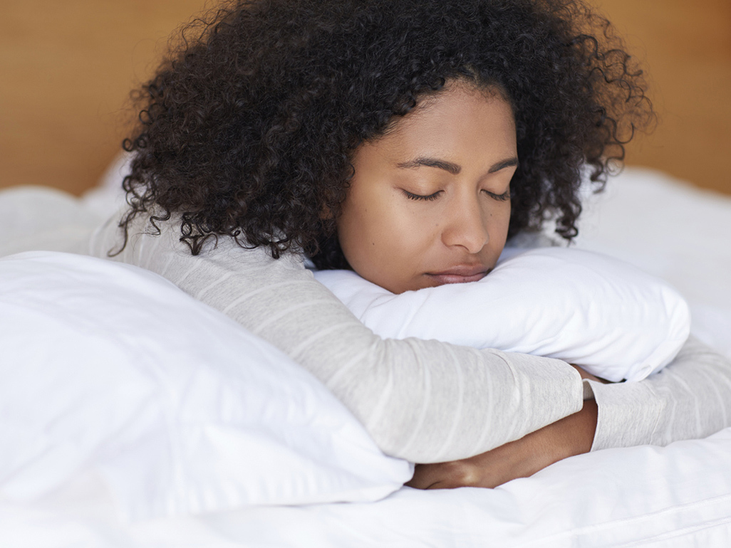 Woman sleeping on her front