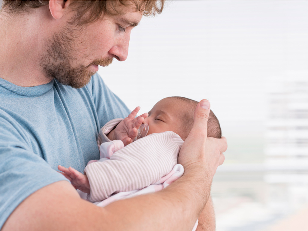 Dad holding newborn
