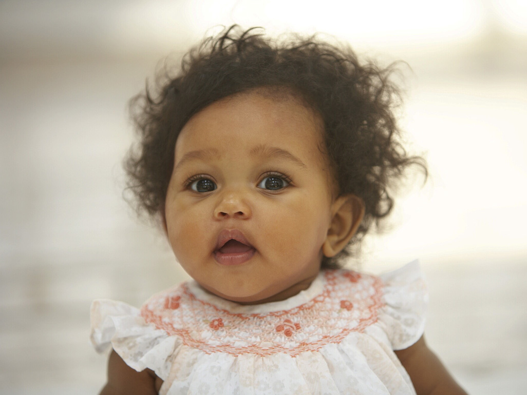 Baby girl wearing pink frilly dress