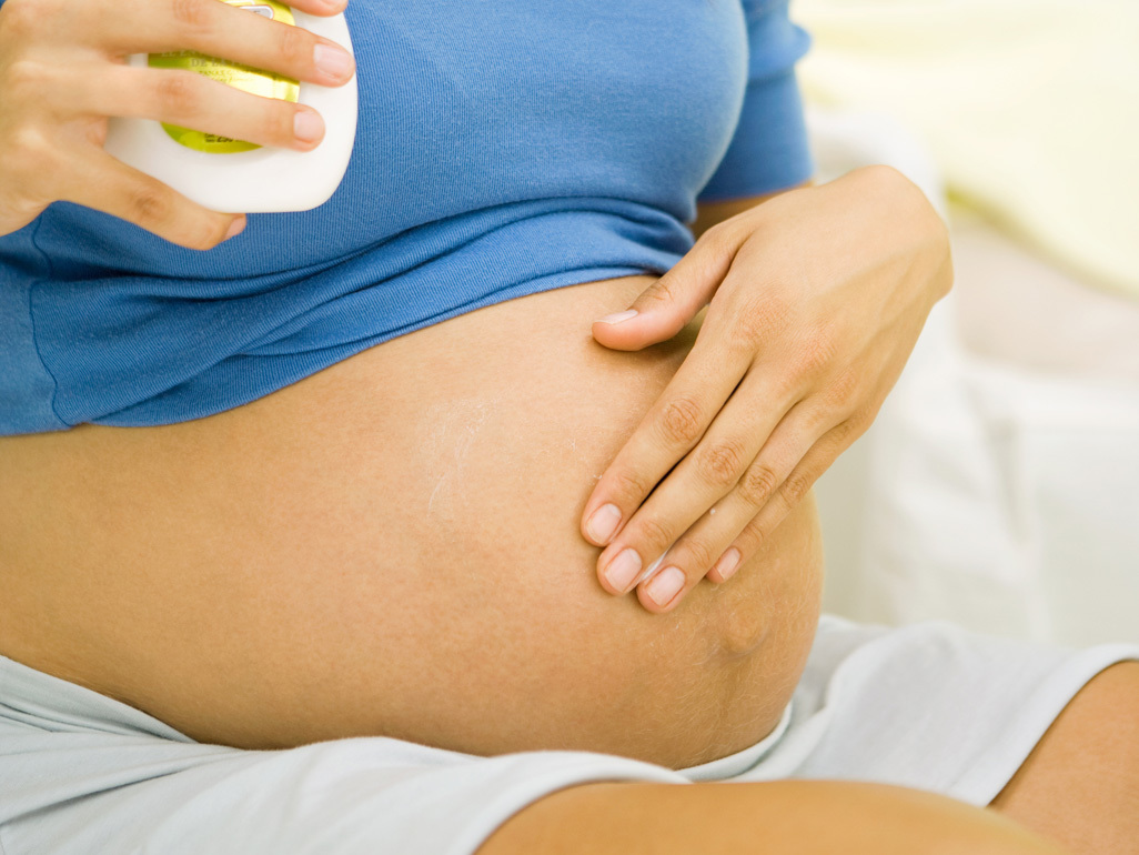 Woman massaging her baby bump