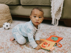 Little boy playing on the carpet