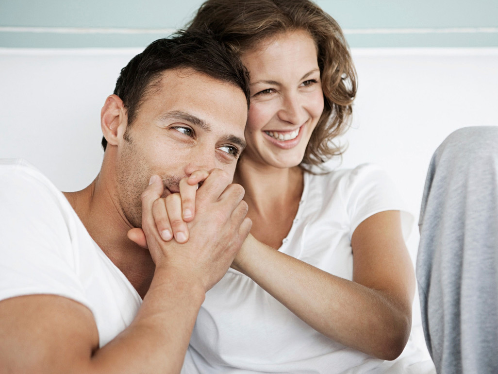 Pregnant woman getting a kiss on the hand from her partner