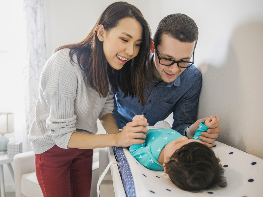 Parents smiling at their baby
